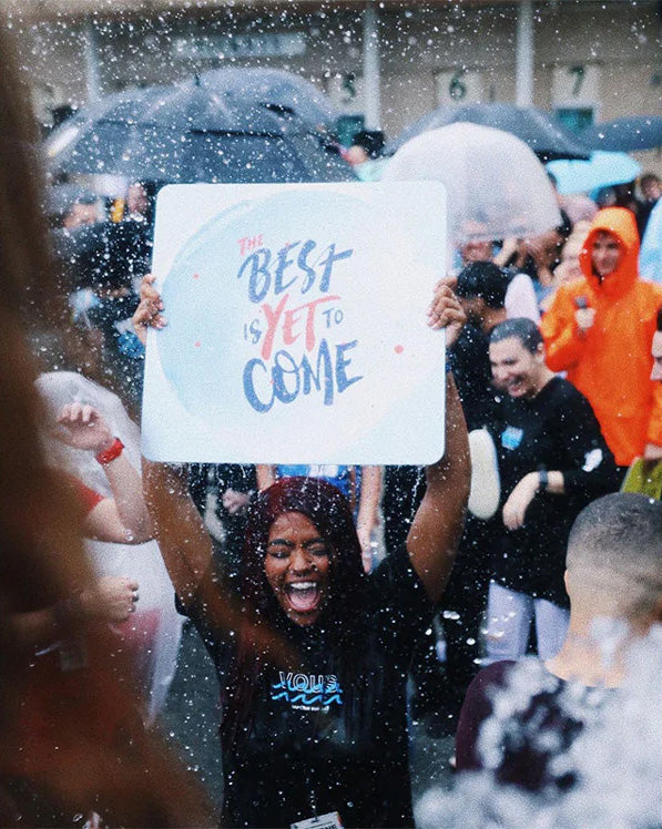 Cheering with a The Best Is Yet To Come Popsign