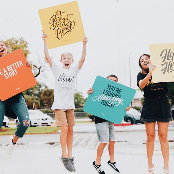 A team jumping with colorful Popsigns